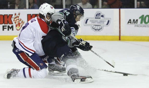 The T-Birds' Alexander Delnov tries to fire a shot while battling the Chiefs' Tyler King.