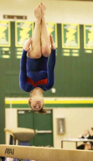 Kent-Meridian's Nora Keith flips off the balance beam and ends her routine with a score of 76.00 at the meet against Kentridge Dec. 10.
