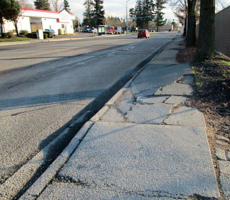 Cracks along Central Avenue South and the sidewalks prior to the city's project to repave the street south of Willis Street. City officials plan similar repairs along the East Valley Highway north of South 196th Street.