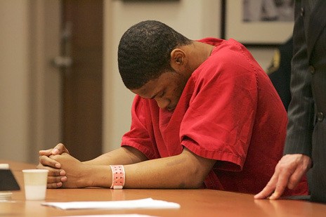 Edward Cobb puts his head down in court Tuesday in Kent before he was sentenced to 39 years in prison for first-degree murder for shooting a Renton teen in 2008 in Kent.