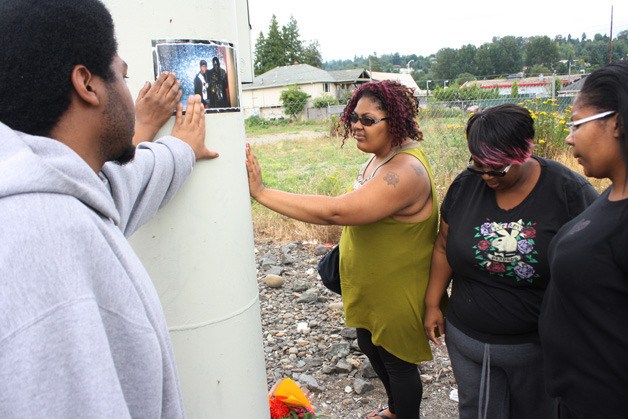 Daryl Cranshaw's family members gather Saturday afternoon at the spot where he died after being struck by a train Friday night. Michael Cranshaw