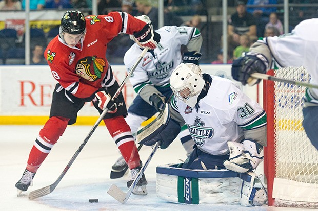 Thunderbirds goalie Landon Bow anticipates a shot from Winterhawks center Cody Glass during WHL action at the ShoWare Center on Saturday night. Bow made 32 saves in Seattle's 2-1 win.