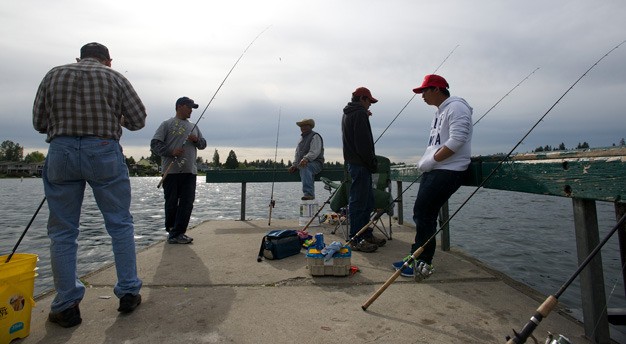 Men try their luck at the Lake Meridian Park fishing dock. Kent city officials hope to replace the dock with state and federal grant money.