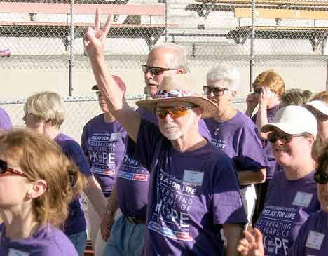 Darryl Tapp raises a victory sign during the survivor lap at last year’s Relay for Life.
