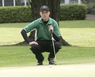 Kentwood junior Kent Hagen lines up a putt during last Thursday’s match against Kentridge. Hagen carded a 39 on the day as the Conquerors secured their second straight South Puget Sound League North Division crown.