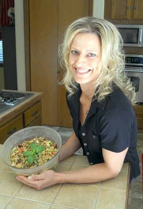 Kent resident Marci Adelsman on Monday shows her dish for a chicken and brown rice salad
