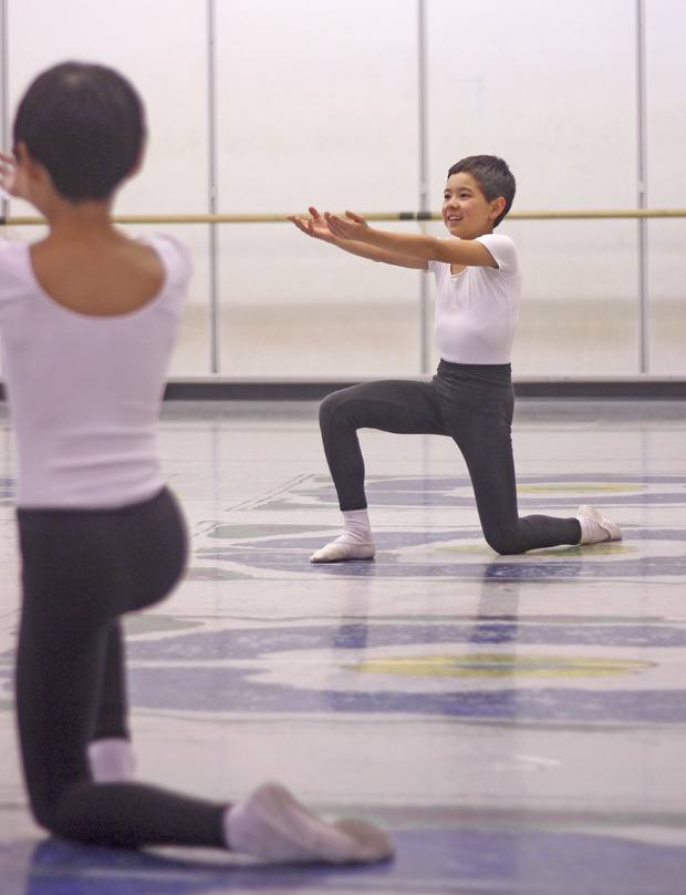 Kent fifth-grader William Dougherty prepares to receive a dancer during rehearsals for Pacific Northwest Ballet's upcoming Nutcracker production. Dougherty is one of 222 students in this year's performance schedule.