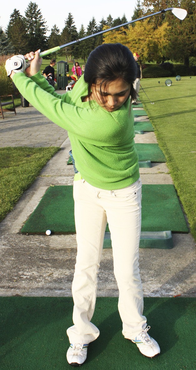 Catherina Li gets practices her swing at the Meridian Valley Country Club. The Kentwood High School sophomore practices golf for at least two hours every day.