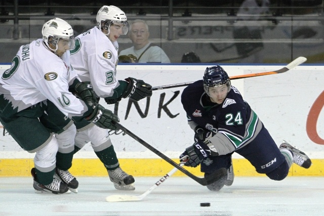 Seattle's Alexander Delnov delivers a pass with a pair of Everett players in pursuit during exhibition play Saturday night.