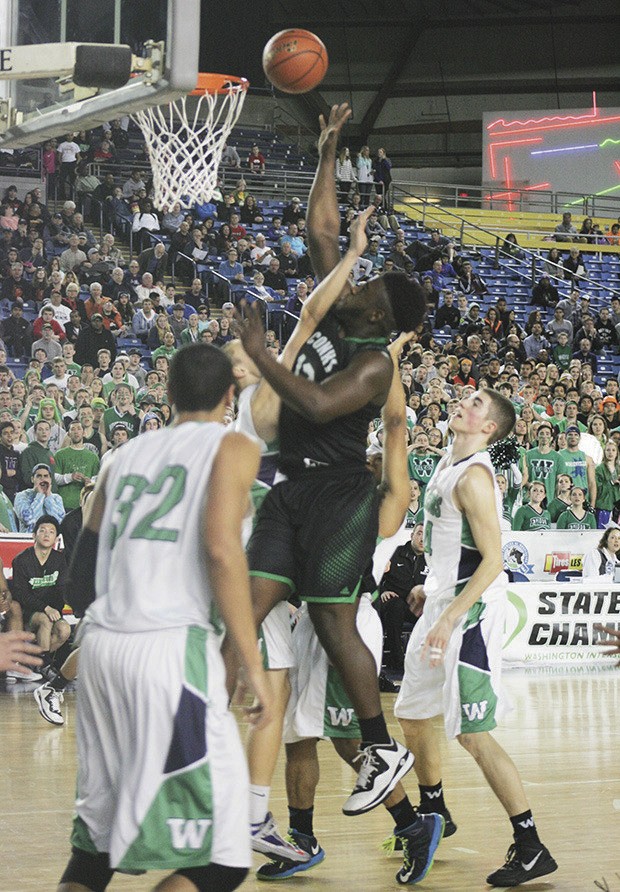 Kentwood’s Josiah Bronson goes up for a rebound against Woodinville in the state tournament last week at the Tacoma Dome. Woodinville won 58-57.