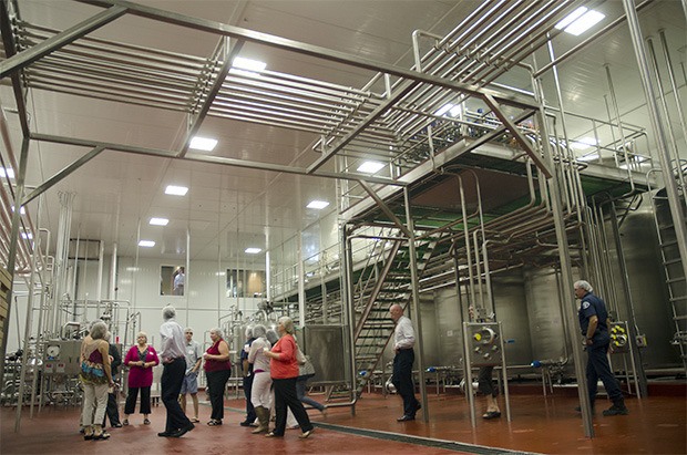Visitors tour the Smith Brothers Farms' packing and shipping area of the new milk plant. Employees and visitors alike commented on the spaciousness of the plant compared to the original farm.