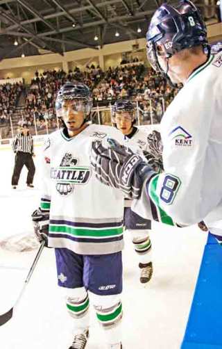 T-Bird Prab Rai gets a high five from teammate Stefan Warg as he gets off the ice in the T-Birds’ first game on ShoWare ice in January.