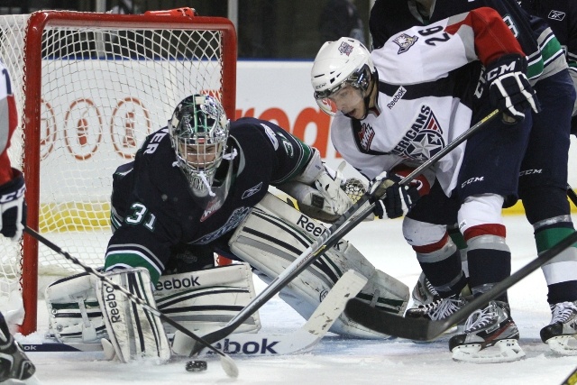 T-Birds goalie Brandon Glover stops a shot by the Americans' Brian Williams. Glover was sensational Friday night