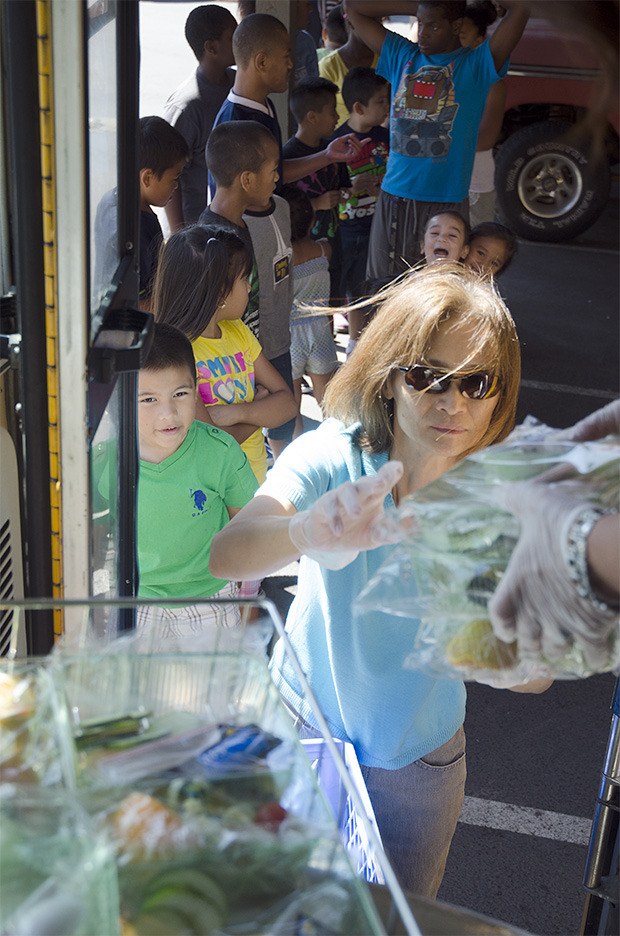 On the go: The Kent School District’s mobile free lunch program serves thousands of children each summer.