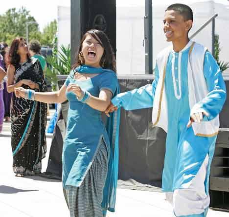 Joanna Pham and Bobby Dhaliwal of Kent-Meridian's Bridging the Seas Indian Club show off their formal clothing during the International Festival Fashion Show Saturday