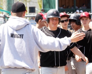 Kentlake's Brandon Cinkovich is congratulated after scoring a run in the first inning on Saturday against Curtis. Kentlake went on to beat Curtis 13-0 to nab the SPSL's No. 5 seed to the district tournament.