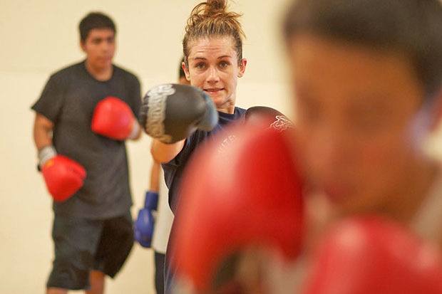 Champion’s form: Seattle’s Jennifer Hamann throws a punch during a workout with young fighters at the Kent’s East Hill Boxing Club last week. Hamann’s visit to the local gym was an opportunity to give back to the boxing community.
