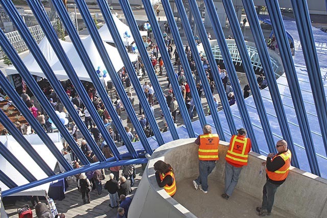 Sound Transit employees observe the dedication ceremony from a parking garage perch at the new Angle Lake Station in SeaTac last Saturday.