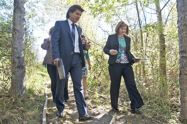 Kent School District Superintendent Edward Vargas speaks with district Environmental Services Supervisor Beth Gilbertson as they walk down the nature trail at Millennium Elementary School.