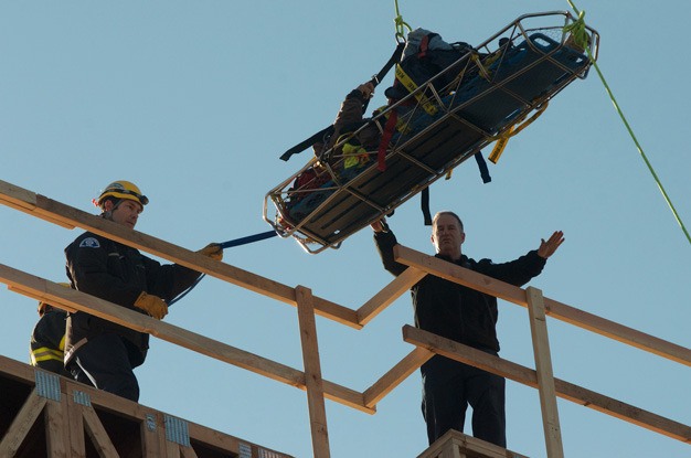 Kent firefighters rescue an injured worker Tuesday from The Platform Apartments under construction at West Smith Street and Fourth Avenue North. The man suffered non-life threatening injuries.