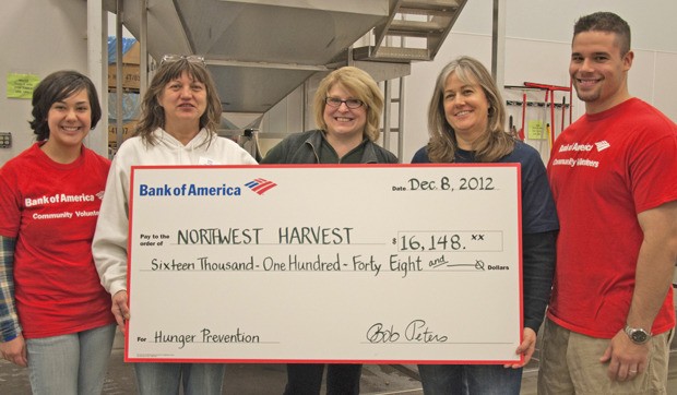 Bank of America volunteers packaged food at the Northwest Harvest Kent facility and presented a check to provide more than 60