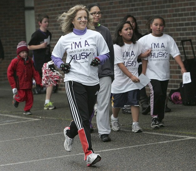 Principal Patty Drobny runs with her staff and students