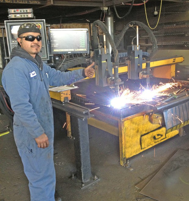 Gabriel Soltero works the plasma cutter in Torklift's new shop.