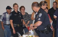 Kent residents and business owners along First Avenue South throw a pizza party at the Kent Police Station to recognize the department's job of cleaning up crime along the street.