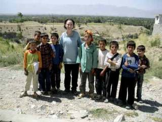 Beverli DeWalt visits with some children in the Kapisa Province of Afghanistan.