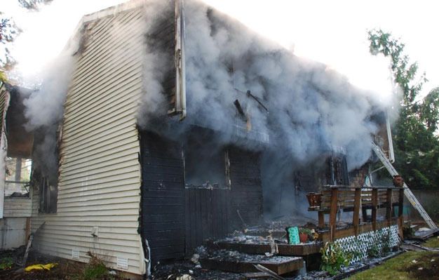 Fire heavily damages a Kent home Friday morning in the 13100 block of Southeast 232nd Court.