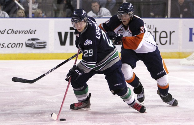 The Thunderbirds' Roberts Lipsbergs looks to pass in front of Kamloops defenseman Sam Grist.