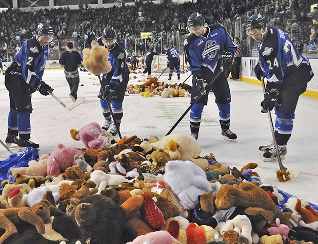 The Thunderbirds help gather a large collection of stuffed animals at last year's Fred Meyer Teddy Bear Toss Game.