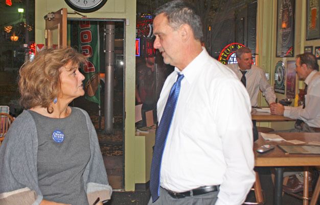 Kent City Councilwoman Elizabeth Albertson and Mark Prothero discuss results of Kent's Proposition 1 Tuesday night during an Election 2012 gathering at the Long Dog Tavern.