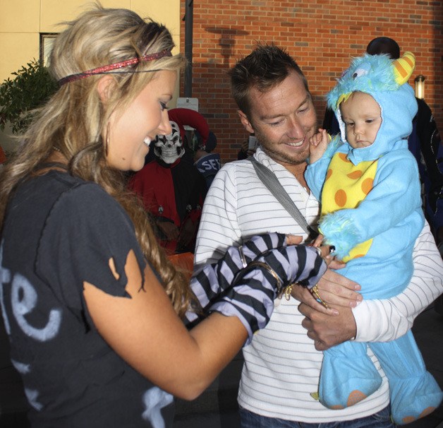 Amanda Henneman with Dilettante Mocha Cafe at Kent Station gives Halloween candy to Alexa Mass