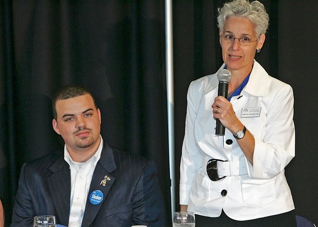 Kent City Councilwoman Debbie Ranniger responds to a question as challenger Bailey Stober listens at the Kent Chamber of Commerce candidate debates Oct. 5 at the ShoWare Center.