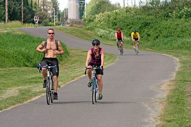 Bicyclists cruise along the Green River Trail in Kent. A new trail will connect the Green River Trail with the Interurban Trail.