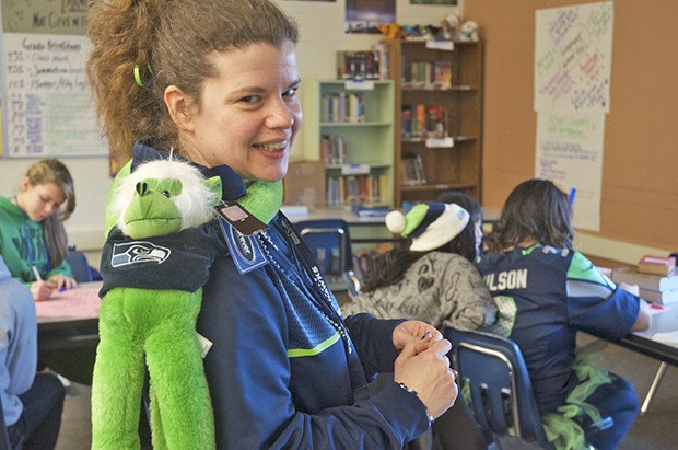 Mill Creek Middle School teacher Nannette Navarro takes a second to show off her green Seahawks monkey