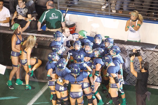 Seattle Mist players huddle during a Lingerie Football League game last August at the ShoWare Center in Kent.