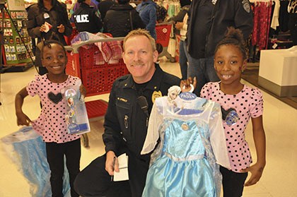 Kent Police Cmdr. Mike O’Reilly helps select dresses from the Disney hit movie