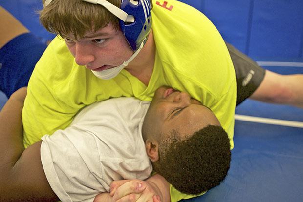 K-M’s Tanner Torr delivers a strong move against Kaleb Oglesby at practice.