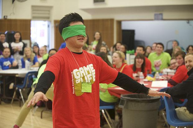 A blindfolded student searches for a chair during a game of blind musical chairs at the Game of Life lunch break.