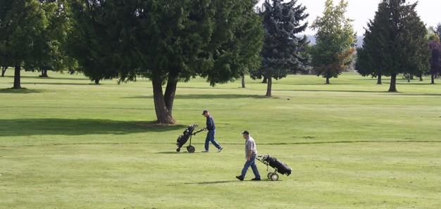 Golfers walk the fairway at Kent's Riverbend Golf Complex par 3 course