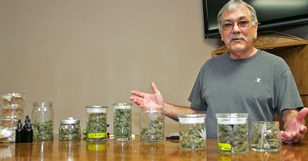 Charles Lambert displays medical marijuana products at Evergreen Association of Collective Gardens in Kent.