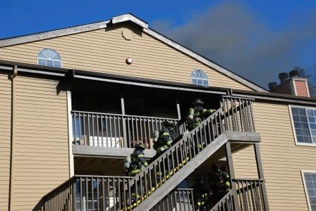 Kent firefighters attack a blaze Sunday at an apartment complex in the 23200 block of 88th Avenue South.