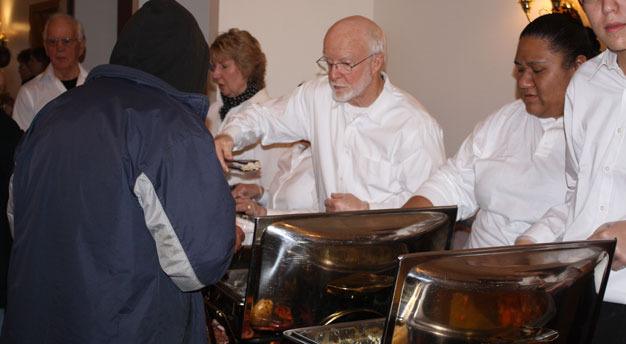 Volunteers serve a Thanksgiving meal at the Golden Steer restaurant on Kent's East Hill.