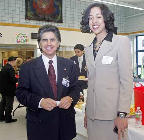 Kent Superintendent Edward Lee Vargas and State Assistant Superintendent for Student Learning Erin Jones pose for a photo after exchanging greetings at Kent-Meridian High School for the launch Feb. 10 of a business/education summit.