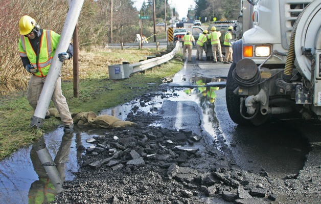 Water over the roadway caused a large pothole on Southeast 256th Street between 146th Ave Southeast and 151st Place Southeast which has the road closed Tuesday