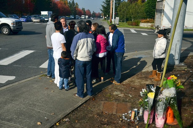 Friends and family of Brandon Gonzalez gather after arranging a memorial at the intersection of 68th Avenue South and South 196th Street in Kent