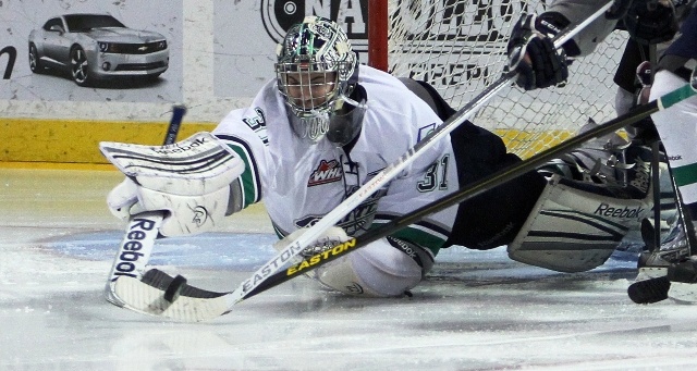 Thunderbirds goalie Brandon Glover stretches to cover the puck. Glover made 28 saves on 29 shots.