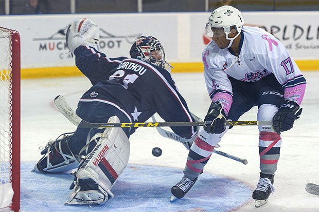 The Thunderbirds' Jamal Watson tries to flip a shot past Americans goalie Evan Sarthou during WHL play Wednesday night at the ShoWare Center.